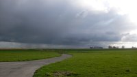 Enorme containerschepen varen op de Elbe. Het fietspad slingert door de uiterwaarden.
